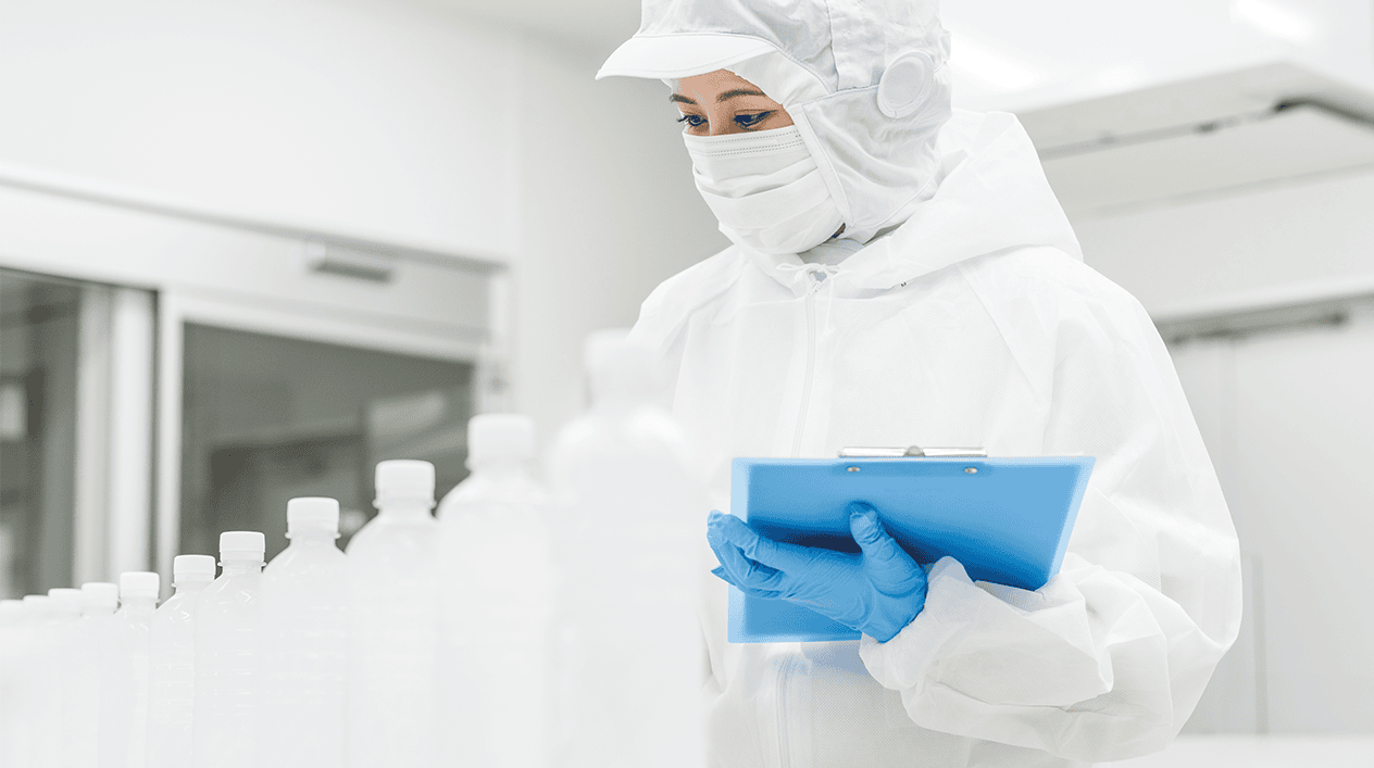 Worker in mask with gloves in a bottle factory